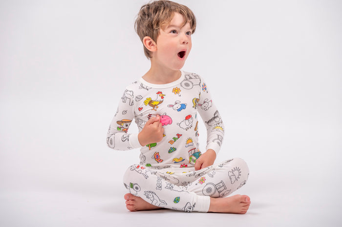 A child wearing his own colorful farm animal pajamas