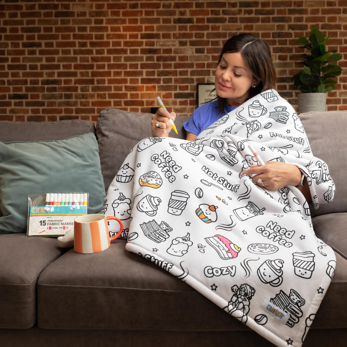 An adult enjoying a quiet moment coloring her coffee blanket